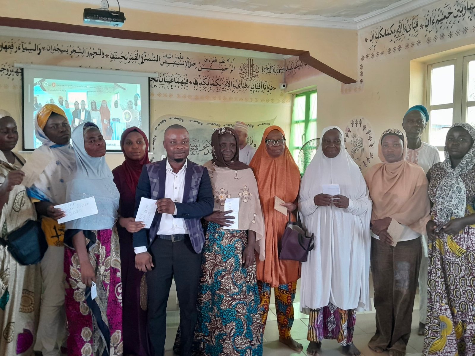 Ramadan Welfare Relief 2025 recipients holding relief envelopes