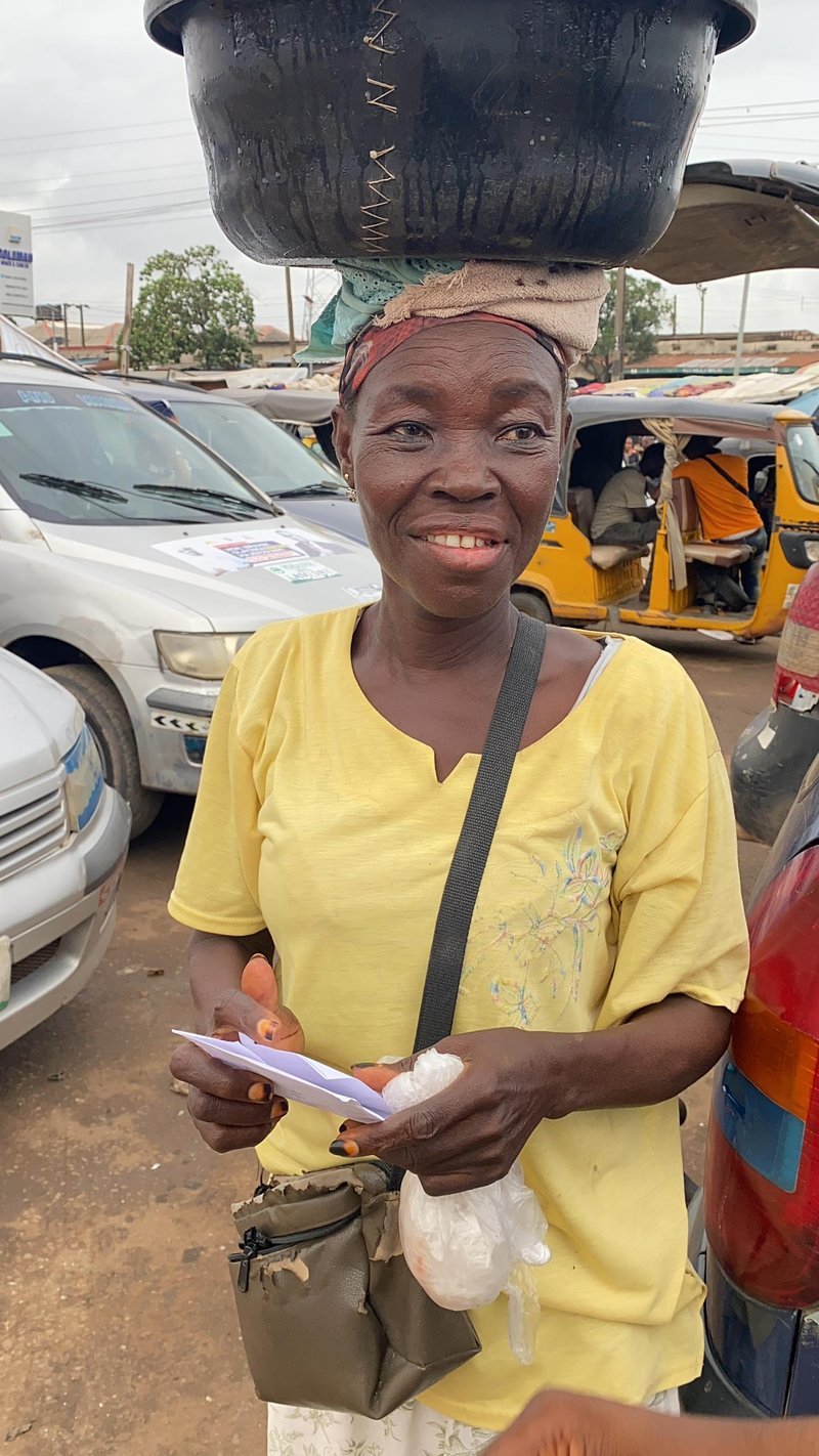 Street hawker carrying goods, smiling